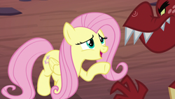 Size: 1280x720 | Tagged: safe, screencap, character:fluttershy, character:garble, species:pegasus, species:pony, episode:sweet and smoky, g4, my little pony: friendship is magic, female, mare, raised hoof, solo focus