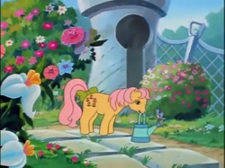 Size: 772x577 | Tagged: safe, screencap, character:posey, species:bird, episode:fugitive flowers, g1, my little pony 'n friends, bow, cute, flower, garden, poseybetes, tail bow, watering can