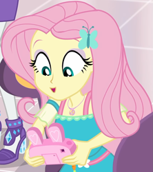 Size: 857x967 | Tagged: safe, screencap, character:fluttershy, character:rarity, equestria girls:holidays unwrapped, g4, my little pony:equestria girls, bunny ears, camera, canterlot mall, chair, clothing, cropped, cute, dashing through the mall, dress, female, flower, geode of fauna, gift giving, hairclip, happy, jewelry, looking down, magical geodes, mall, necklace, present, shyabetes, sitting, smiling, table, waistband