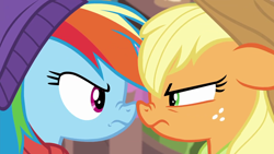 Size: 1280x720 | Tagged: safe, screencap, character:applejack, character:rainbow dash, species:earth pony, species:pegasus, species:pony, episode:triple pony dare ya, applejack is not amused, applejack's hat, competitive, cowboy hat, determined, duo, female, freckles, frown, glare, green eyes, looking at each other, magenta eyes, mare, multicolored hair, narrowed eyes, nose wrinkle, noseboop, rainbow dash is not amused, rivalry, stetson, unamused, winter cap