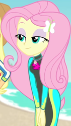 Size: 460x814 | Tagged: safe, screencap, character:applejack, character:fluttershy, equestria girls:forgotten friendship, g4, my little pony:equestria girls, beach, bodysuit, butterfly, clothing, cloud, cropped, cute, female, geode of fauna, hairclip, hands together, jewelry, lidded eyes, long sleeves, magical geodes, necklace, ocean, sand, shyabetes, smiling, swimsuit, wetsuit