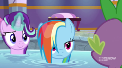 Size: 1280x720 | Tagged: safe, screencap, character:rainbow dash, character:spike, character:starlight glimmer, species:dragon, species:pegasus, species:pony, species:unicorn, episode:deep tissue memories, 9now, baby dragon, female, frown, glowing horn, hair flip, hair over one eye, hot tub, looking at someone, magic, male, mare, multicolored hair, narrowed eyes, offscreen character, ponyville spa, rainbow dash is not amused, raised eyebrow, smiling, trio, unamused, water, wet, wet mane, wet mane rainbow dash