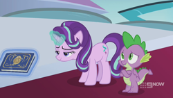 Size: 1280x720 | Tagged: safe, screencap, character:spike, character:starlight glimmer, species:dragon, species:pony, species:unicorn, episode:memories and more, 9now, book, crossed arms, duo, levitation, magic, magic aura, mid-blink screencap, scrapbook, telekinesis, winged spike