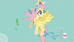 Size: 1450x816 | Tagged: safe, screencap, character:fluttershy, species:pegasus, species:pony, episode:testing testing 1-2-3, g4, my little pony: friendship is magic, celestia costume, celestia's crown, clothing, costume, crown, fake horn, female, flying, grin, hub logo, jewelry, mare, peytral, regalia, shylestia, smiling, solo