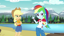 Size: 1280x720 | Tagged: safe, screencap, character:applejack, character:rainbow dash, equestria girls:legend of everfree, g4, my little pony:equestria girls, clothing, cowboy hat, crossed arms, denim, freckles, hat, lake, lifejacket, mountain, mountain range, pants, pointing, scenery, shorts, smirk, stetson, tree