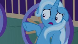 Size: 1280x720 | Tagged: safe, screencap, character:trixie, species:pony, episode:to where and back again, g4, my little pony: friendship is magic, floppy ears, open mouth, pointing, scared, shrunken pupils, solo, trixie's wagon, underhoof, wheel
