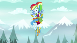 Size: 1280x720 | Tagged: safe, screencap, character:rainbow dash, equestria girls:legend of everfree, g4, my little pony:equestria girls, clothing, crystal guardian, crystal wings, female, flying, legend you were meant to be, mountain, pants, ponied up, shoes, shoulder bag, sneakers, solo, super ponied up, tree, winged shoes, wings
