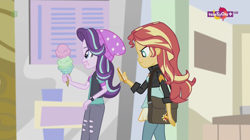 Size: 1136x638 | Tagged: safe, screencap, character:starlight glimmer, character:sunset shimmer, equestria girls:mirror magic, g4, my little pony:equestria girls, beanie, canterlot mall, cellphone, clothing, female, food, geode of empathy, hat, ice cream, magical geodes, phone, teletoon
