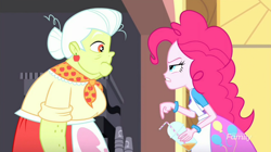Size: 1278x718 | Tagged: safe, screencap, character:granny smith, character:pinkie pie, episode:the art of friendship, eqg summertime shorts, g4, my little pony:equestria girls, apron, bracelet, bun, clothing, confused, ear piercing, earring, jewelry, juice, lunchlady smith, piercing, scarf, straw