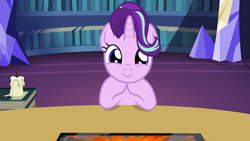 Size: 1920x1080 | Tagged: safe, screencap, character:starlight glimmer, species:pony, species:unicorn, episode:uncommon bond, g4, my little pony: friendship is magic, board game, book, bookshelf, c:, candle, cute, dragon pit, female, glimmerbetes, hair flip, hair over one eye, horn, looking at you, mare, smiling, table, twilight's castle, weapons-grade cute