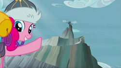 Size: 1343x758 | Tagged: safe, screencap, character:pinkie pie, species:earth pony, species:pony, episode:the lost treasure of griffonstone, g4, my little pony: friendship is magic, abysmal abyss, clothing, female, griffonstone, hat, looking back, mare, mountain, peak, pointing, raised hoof, smiling, solo, worm's eye view