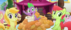 Size: 1920x804 | Tagged: safe, screencap, character:apple cobbler, character:carrot top, character:gala appleby, character:golden harvest, character:jonagold, character:peachy sweet, character:pink lady, character:red gala, character:spike, species:dragon, species:earth pony, species:pony, my little pony: the movie (2017), apple family member, background pony, barrel, bow, faec, female, food, hair bow, happy, irrational exuberance, mare, quill, smiling, we got this together