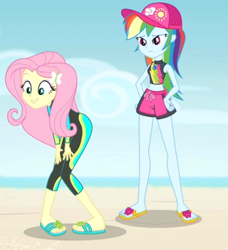 Size: 580x635 | Tagged: safe, screencap, character:fluttershy, character:rainbow dash, my little pony:equestria girls, adorasexy, aww... baby turtles, beach, belly button, bent over, clothing, curvy, cute, eyes on the prize, feet, flip-flops, hips, midriff, ocean, out of context, sandals, sexy, shorts, shyabetes, swimsuit, wetsuit