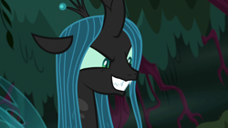 Size: 1280x720 | Tagged: safe, screencap, character:queen chrysalis, species:changeling, episode:the mean 6, g4, my little pony: friendship is magic, changeling queen, everfree forest, evil grin, fangs, female, forest, former queen chrysalis, grin, plotting, smiling, solo