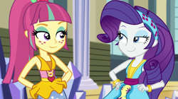 Size: 1912x1072 | Tagged: safe, screencap, character:rarity, character:sour sweet, equestria girls:dance magic, g4, my little pony:equestria girls, :j, canterlot high, clothing, dress, duo, female, freckles, hand on hip, headband, lidded eyes, ponytail, skirt, smiling, teletoon