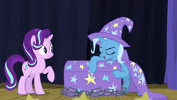 Size: 1920x1080 | Tagged: safe, screencap, character:starlight glimmer, character:trixie, species:pony, species:unicorn, episode:on the road to friendship, cape, chains, chest, clothing, female, hat, mare, stage, trixie's cape, trixie's hat