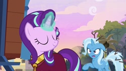 Size: 1920x1080 | Tagged: safe, screencap, character:starlight glimmer, character:trixie, species:pony, species:unicorn, episode:on the road to friendship, clothing, discovery family logo, duo, eyes closed, female, glowing horn, magic, magic aura, mare, messy mane, robe, smiling