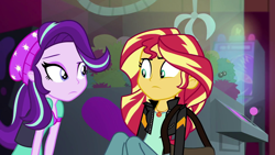 Size: 1920x1080 | Tagged: safe, screencap, character:starlight glimmer, character:sunset shimmer, equestria girls:mirror magic, g4, my little pony:equestria girls, beanie, claw machine, clothing, female, hat, looking at each other, messenger bag