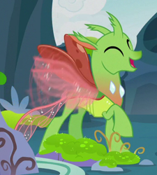 Size: 348x387 | Tagged: safe, screencap, species:changeling, species:reformed changeling, episode:to change a changeling, g4, my little pony: friendship is magic, background changeling, buzzing wings, cropped, eyes closed, happy, open mouth, raised hoof, solo, wings