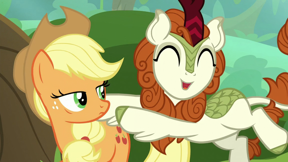 Size: 1150x646 | Tagged: safe, screencap, character:applejack, character:autumn blaze, species:earth pony, species:kirin, species:pony, episode:sounds of silence, g4, my little pony: friendship is magic, animated, awwtumn blaze, cute, hug, snuggling, uncomfortable