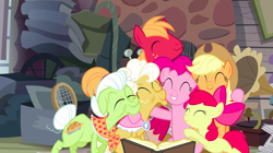 Size: 1440x808 | Tagged: safe, screencap, character:apple bloom, character:applejack, character:big mcintosh, character:goldie delicious, character:granny smith, character:pinkie pie, species:earth pony, species:pony, episode:pinkie apple pie, g4, my little pony: friendship is magic, apple family, book, elderly, eyes closed, family, female, filly, foal, group hug, hug, male, mare, stallion