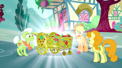 Size: 1440x807 | Tagged: safe, screencap, character:applejack, character:carrot top, character:golden harvest, character:granny smith, species:earth pony, species:pony, episode:inspiration manifestation, g4, my little pony: friendship is magic, apple, apple cart, bedazzled, female, food, gem, gold, mare, raised hoof, shiny, surprised, trio