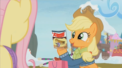 Size: 1348x752 | Tagged: safe, screencap, character:applejack, character:fluttershy, species:earth pony, species:pony, episode:best gift ever, g4, my little pony: friendship is magic, bag, baton, clothing, comic book, female, mare, snow, solo focus, sweater