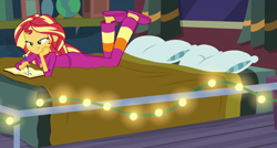 Size: 1170x629 | Tagged: safe, screencap, character:sunset shimmer, equestria girls:forgotten friendship, g4, my little pony:equestria girls, ass, bed, bunset shimmer, clothing, cropped, string lights, sunset's apartment, tongue out, writing