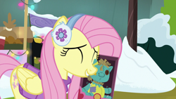 Size: 1280x720 | Tagged: safe, screencap, character:fluttershy, species:pegasus, species:pony, episode:best gift ever, g4, my little pony: friendship is magic, clothing, cute, earmuffs, eyes closed, female, happy, holly the hearths warmer doll, mare, nuzzles, nuzzling, shyabetes, smiling, sweater