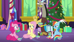 Size: 1280x720 | Tagged: safe, screencap, character:discord, character:fluttershy, character:pinkie pie, character:rainbow dash, species:draconequus, species:earth pony, species:pegasus, species:pony, episode:best gift ever, g4, my little pony: friendship is magic, bowl, female, food, hearth's warming tree, holly the hearths warmer doll, mare, present, pudding, puddinghead's pudding, sitting, spoon, tree