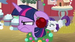 Size: 1280x720 | Tagged: safe, screencap, character:rarity, character:twilight sparkle, character:twilight sparkle (alicorn), species:alicorn, species:pony, episode:the great escape room, christmas wreath, female, floppy ears, glare, hay, hearth's warming shorts, ornament, twilight is not amused, unamused, wavy mouth, wreath
