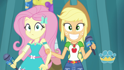 Size: 1920x1080 | Tagged: safe, screencap, character:applejack, character:fluttershy, episode:best in show: the pre-show, g4, my little pony:equestria girls, geode of fauna, geode of super strength, grin, magical geodes, microphone, smiling