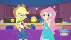 Size: 1920x1080 | Tagged: safe, screencap, character:applejack, character:fluttershy, episode:best in show: the victory lap, g4, my little pony:equestria girls, geode of fauna, geode of super strength, looking at you, magical geodes, microphone, playing with hair