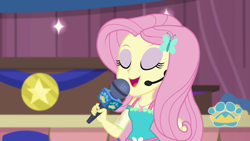 Size: 1280x720 | Tagged: safe, screencap, character:fluttershy, episode:best in show: the victory lap, g4, my little pony:equestria girls, eyes closed, eyeshadow, makeup, microphone, open mouth, smiling, solo