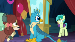 Size: 1280x720 | Tagged: safe, screencap, character:gallus, character:sandbar, character:yona, species:earth pony, species:griffon, species:pony, species:yak, episode:uprooted, g4, my little pony: friendship is magic, balloon, bow, claws, cloven hooves, earmuffs, female, hair bow, hoof hold, hooves, male, monkey swings, raised hoof, tail, teenager, wings