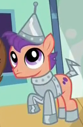 Size: 263x400 | Tagged: safe, screencap, species:earth pony, species:pony, episode:made in manehattan, g4, my little pony: friendship is magic, background pony, clothing, colt, costume, cropped, foal, male, solo, solo focus, the wizard of oz, tin man, tin orbit