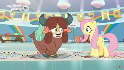 Size: 1366x768 | Tagged: safe, screencap, character:fluttershy, character:yona, species:pegasus, species:pony, species:yak, episode:she's all yak, g4, my little pony: friendship is magic, bow, cloven hooves, crossed hooves, dotted line, duo, female, gym, hair bow, hoofprints, mare, monkey swings, paper, twisting