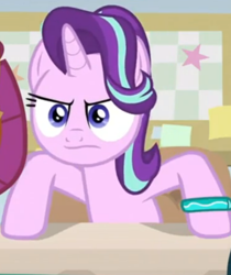 Size: 558x665 | Tagged: safe, screencap, character:smolder, character:starlight glimmer, species:alicorn, species:dragon, species:pony, episode:student counsel, angry, bracelet, cropped, dragoness, female, frown, hooves on the table, jewelry, mare, offscreen character, solo focus, starlight is not amused, starlight's bracelet, unamused