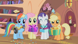 Size: 800x450 | Tagged: safe, screencap, character:applejack, character:fluttershy, character:rainbow dash, character:rarity, species:earth pony, species:pegasus, species:pony, species:unicorn, episode:secret of my excess, g4, my little pony: friendship is magic, female, golden oaks library, mare, mouth hold, present