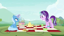 Size: 1920x1080 | Tagged: safe, screencap, character:starlight glimmer, character:trixie, species:pony, species:unicorn, episode:student counsel, bracelet, cup, duo, female, jewelry, magic, magic aura, mare, pager, picnic, picnic blanket, starlight's bracelet, starlight's hoofband, teacup, teapot, telekinesis