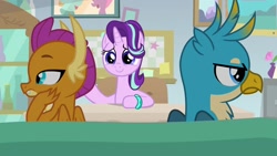 Size: 1920x1080 | Tagged: safe, screencap, character:gallus, character:smolder, character:starlight glimmer, species:dragon, species:griffon, species:pony, species:unicorn, episode:student counsel, angry, annoyed, bickering, bracelet, claws, couch, desk, dragoness, duo, facing away, female, folded wings, frown, gallus is not amused, guidance counselor, hand on cheek, indifferent, jewelry, lidded eyes, male, mare, scowl, starlight's office, trio, unamused, wings