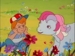 Size: 641x480 | Tagged: safe, screencap, character:danny williams, character:sweet stuff, episode:the magic coins, g1, my little pony 'n friends, baseball cap, cap, clothing, cute, flower, hat, sweet sweet stuff