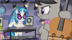 Size: 1669x941 | Tagged: safe, screencap, character:dj pon-3, character:octavia melody, character:vinyl scratch, species:earth pony, species:pony, species:unicorn, episode:slice of life, g4, my little pony: friendship is magic, background pony, bipedal, bow, cello, cropped, disco ball, duo, evil grin, female, grin, headphones, looking at each other, mare, musical instrument, playing instrument, smiling, smirk, synthesizer, turntable
