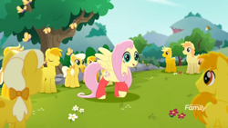 Size: 1366x768 | Tagged: safe, screencap, character:fluttershy, species:earth pony, species:pegasus, species:pony, friendship is magic: rainbow roadtrip, g4, my little pony: friendship is magic, background pony, bow, butterfly, clones, clothing, crowd, discovery family logo, dot cutie mark, female, flower, hair bow, hill, leg warmers, male, mane bow, mare, raised hoof, stallion, tree, unnamed pony, yellow, yellow pony