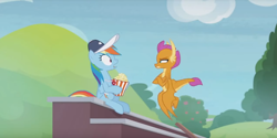 Size: 1224x614 | Tagged: safe, screencap, character:rainbow dash, character:smolder, species:dragon, species:pegasus, species:pony, episode:2-4-6 greaaat, claws, clothing, coach, dragoness, duo, female, flapping, flying, folded wings, food, hat, horns, mare, narrowed eyes, popcorn, shrunken pupils, sitting, smolder is not amused, spread wings, squint, teenaged dragon, teenager, wide eyes, wings