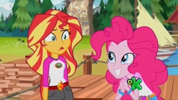 Size: 1280x720 | Tagged: safe, screencap, character:pinkie pie, character:sunset shimmer, equestria girls:legend of everfree, g4, my little pony:equestria girls, belt, boat, camp everfree outfits, confused, discovery kids, duo, duo female, female, grin, smiling