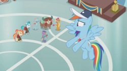 Size: 1362x766 | Tagged: safe, screencap, character:lighthoof, character:ocellus, character:rainbow dash, character:shimmy shake, character:smolder, character:snips, character:yona, species:changedling, episode:2-4-6 greaaat, blurry, cap, clothing, face paint, flying, gym, hat, podium, top hat, unsure, whistle