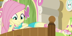 Size: 880x445 | Tagged: safe, screencap, character:angel bunny, character:fluttershy, episode:do it for the ponygram!, g4, my little pony:equestria girls, bed, cropped, cute, female, fluttershy's bedroom, geode of fauna, hand on face, in bed, jewelry, legs, looking down, magical geodes, reading, sandals, shyabetes, smiling, solo