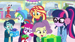 Size: 1280x720 | Tagged: safe, screencap, character:sunset shimmer, character:twilight sparkle, character:twilight sparkle (scitwi), species:eqg human, equestria girls:holidays unwrapped, g4, my little pony:equestria girls, canterlot mall, clothing, earmuffs, female, glasses, henry handle, kids, lily pad (equestria girls), little red, male, manestrum, plusplus, present, winter outfit