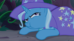 Size: 1280x720 | Tagged: safe, screencap, character:trixie, species:pony, species:unicorn, episode:student counsel, cape, chewing, clothing, eating, female, forest, hat, mare, munching, nose wrinkle, prone, solo, trixie's cape, trixie's hat